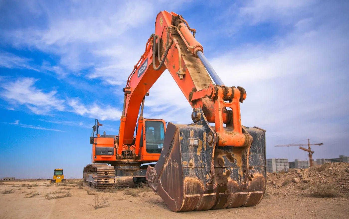 An orange digger on a building site