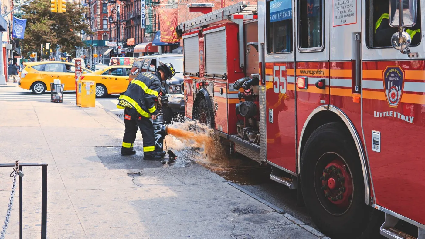 A fire engine and a firefighter on a New York street